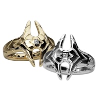 a silver and gold ring with a diamond in the middle