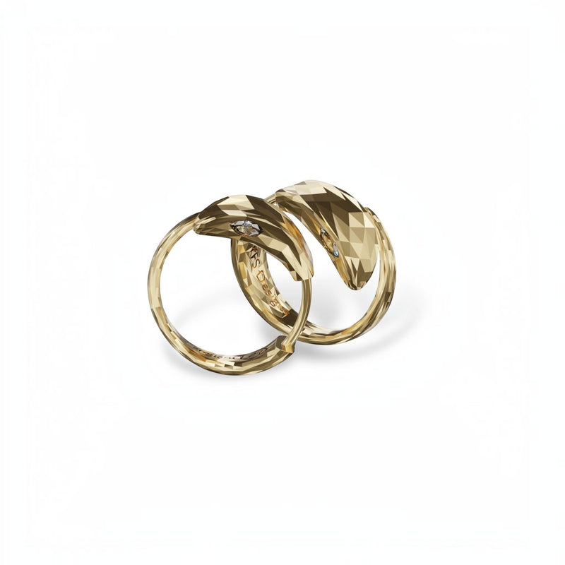 YFS Designs gold snake huggie earrings with faceted texture and sparkling moissanite stone accents.