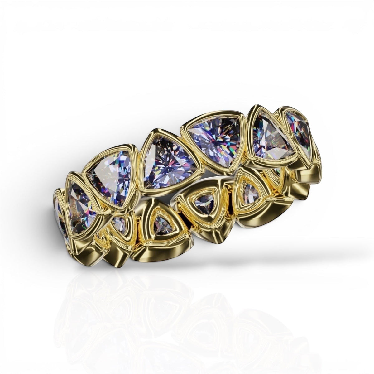 YFS Designs 4mm trillion faceted tanzanite bezel band in yellow gold with a reflective white background.
