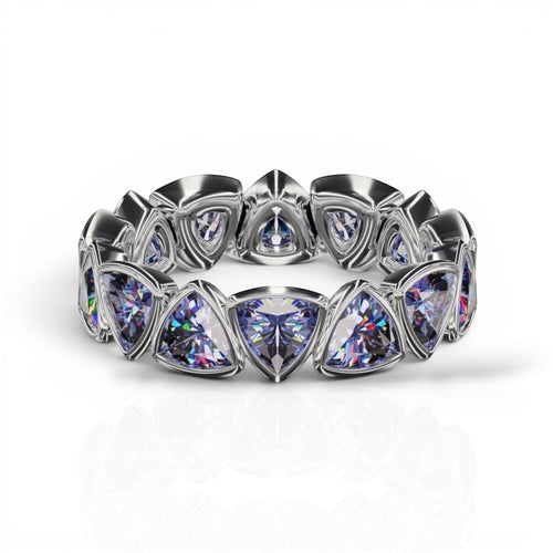 YFS Designs 4mm trillion faceted tanzanite eternity band set in a polished silver bezel setting.
