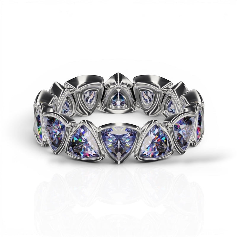 YFS Designs 4mm trillion faceted tanzanite eternity band set in a polished silver bezel setting.